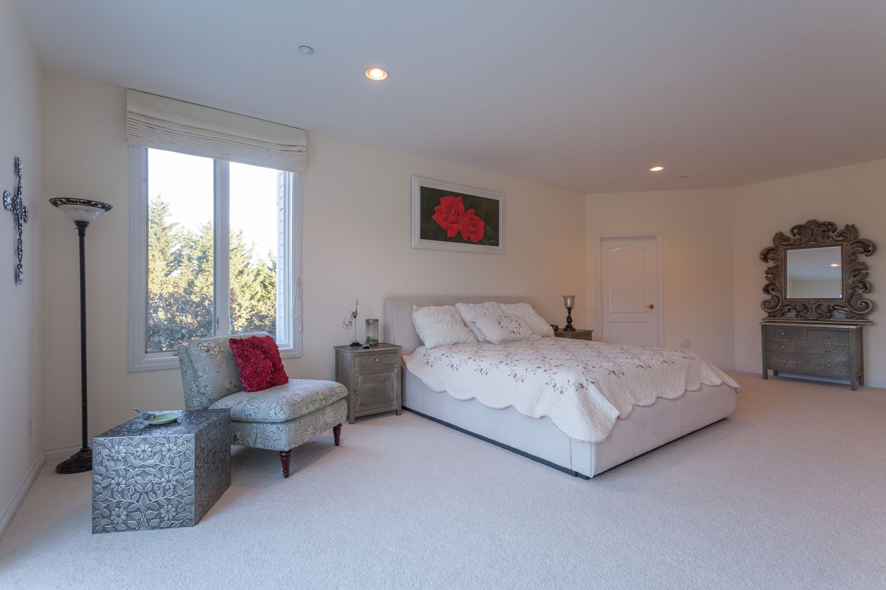 Bedroom with king bed and sitting chair