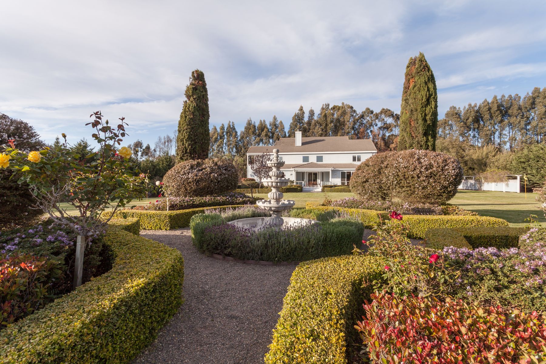 Formal garden and fountain with the house behind