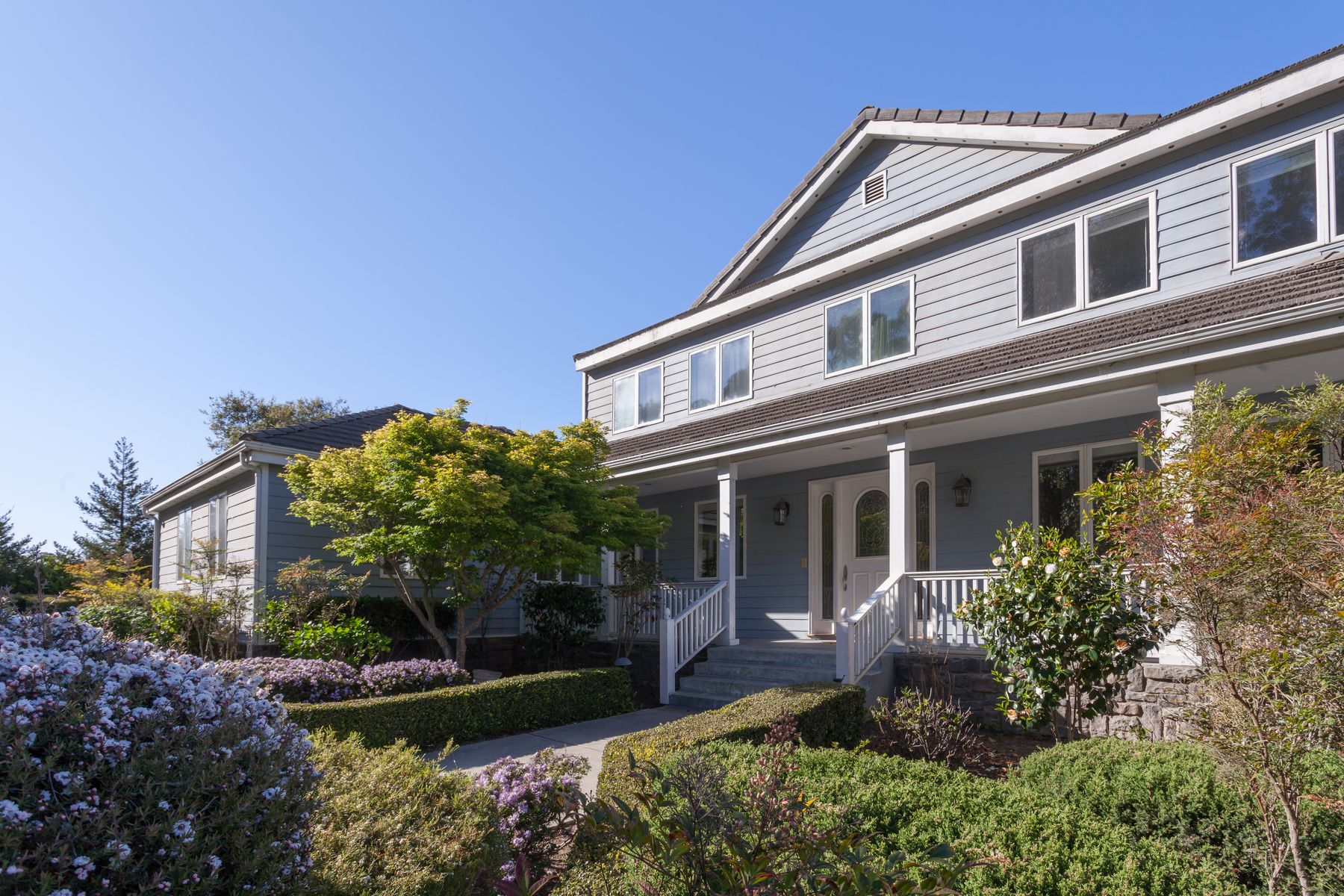 The front porch and gardens of the house